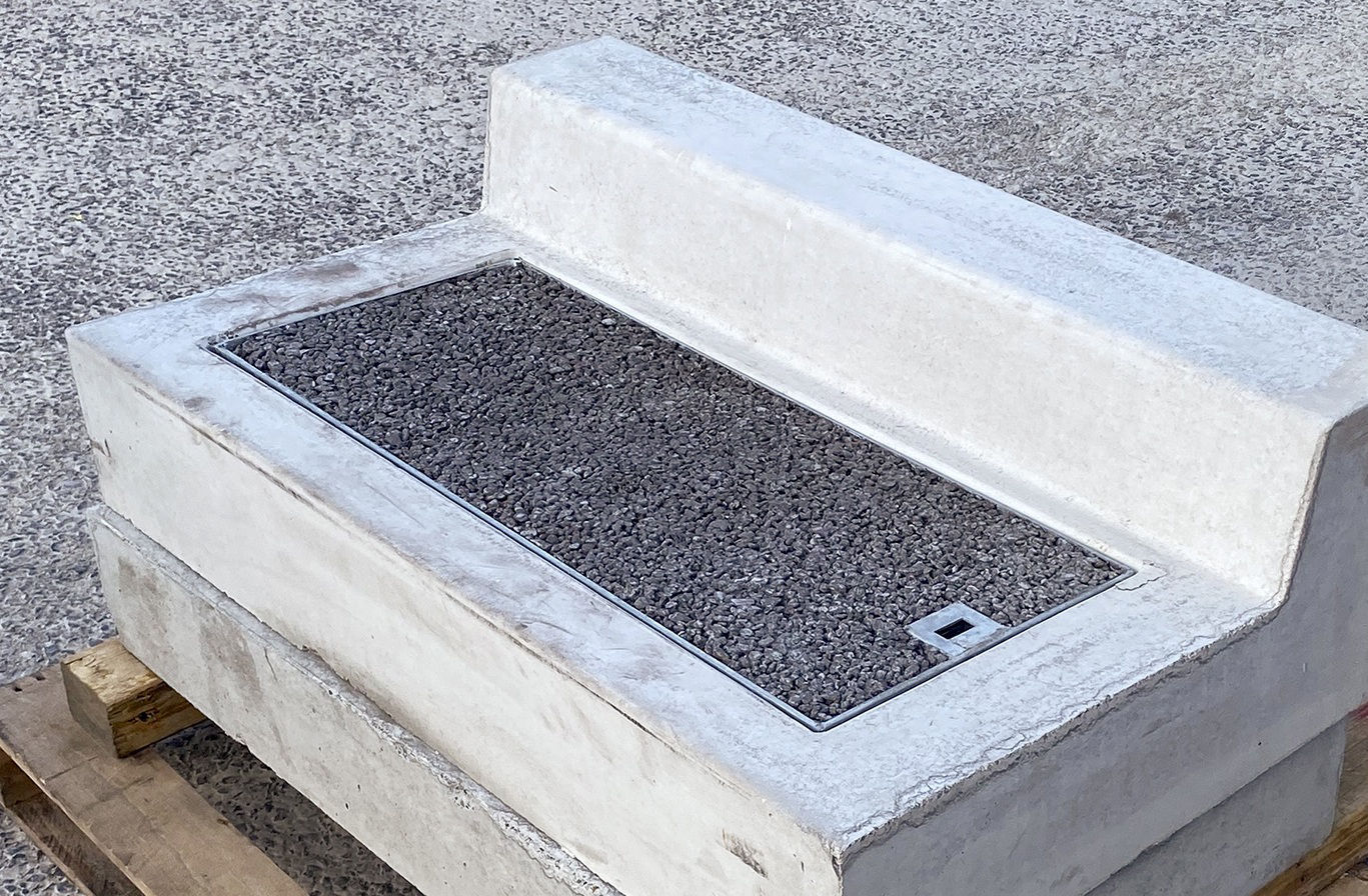 EFFI unit on a pallet – precast concrete kerb body with a galvanised steel tray filled with permeable concrete, set on a precast water ramp