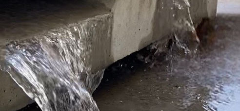 Water flowing through the permeable kerb face during a test