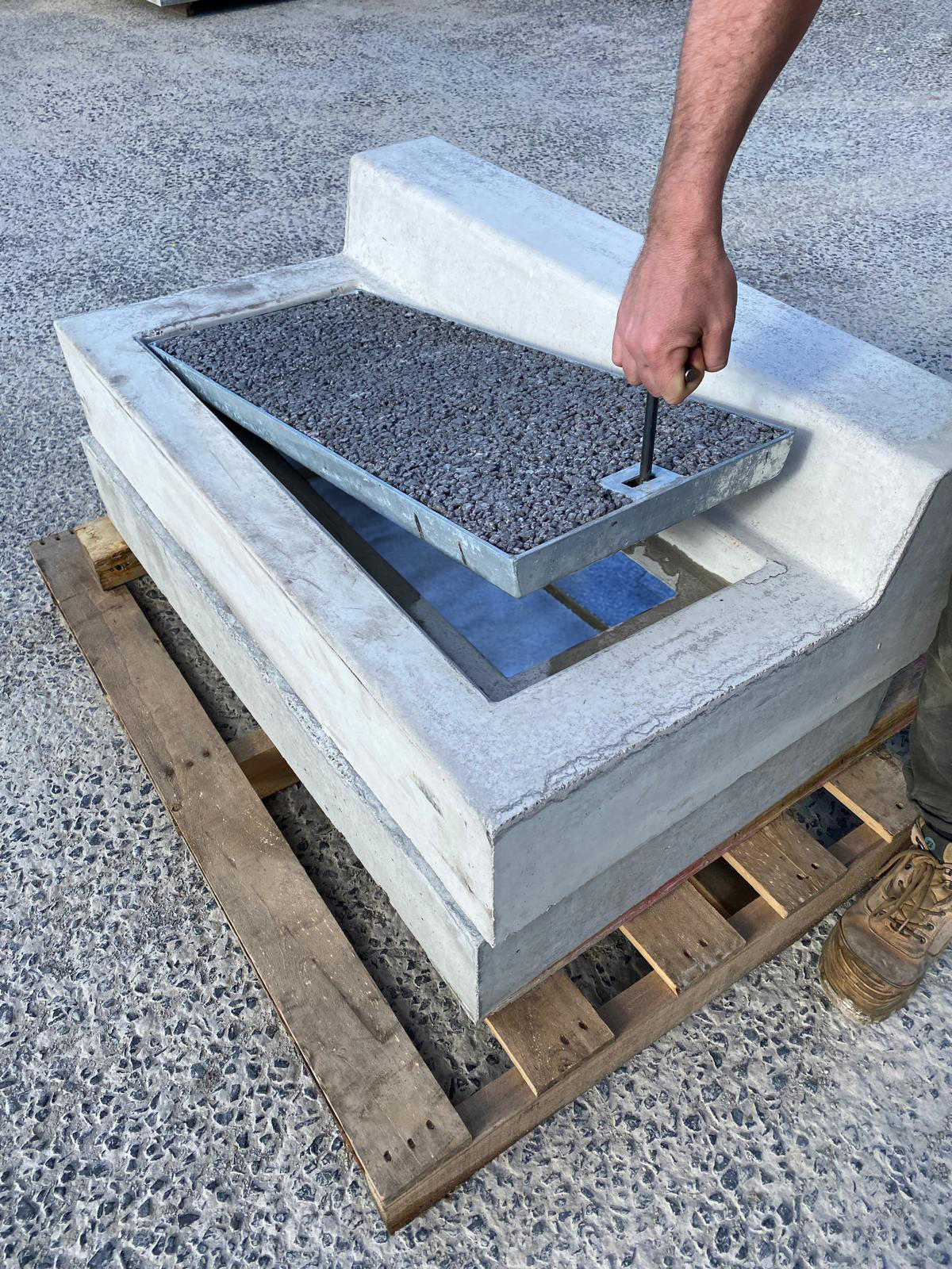 ETI tray lifted with a hex key, the blue ARI Water Filter visible in the chamber beneath